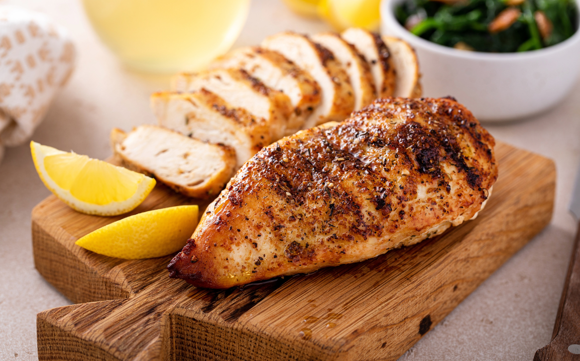 Grilled chicken and lemons on a serving platter
