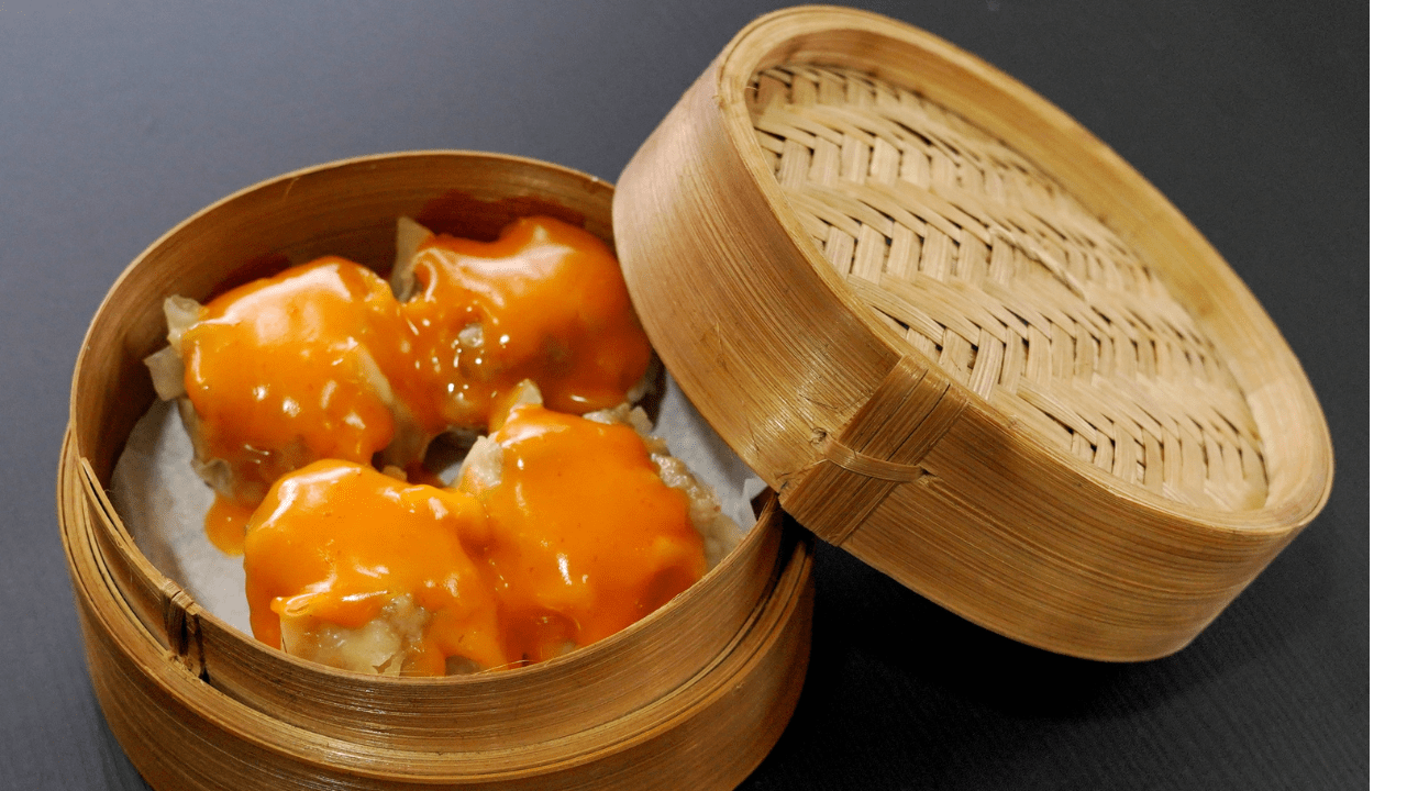 Dim sum with melted cheese in container