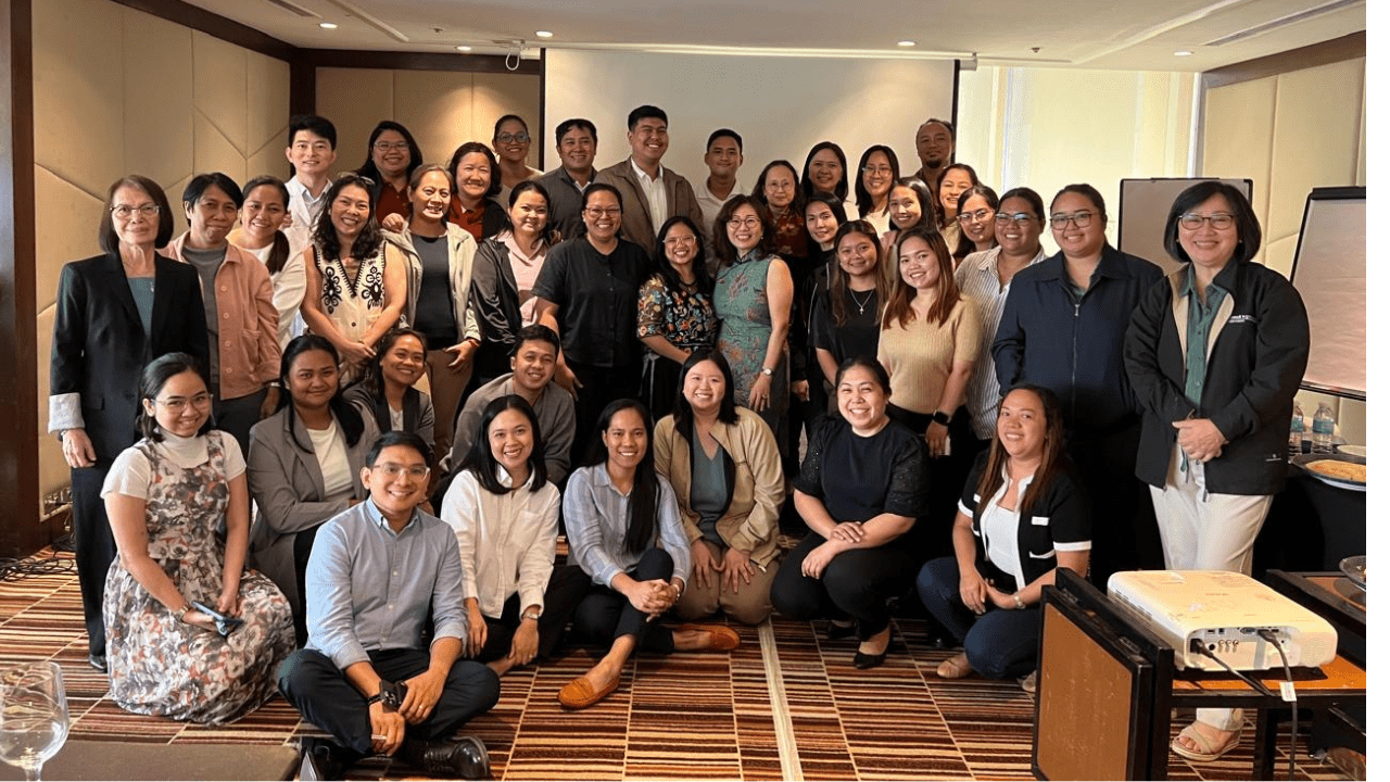 Group photo of about 40 people in a conference room.